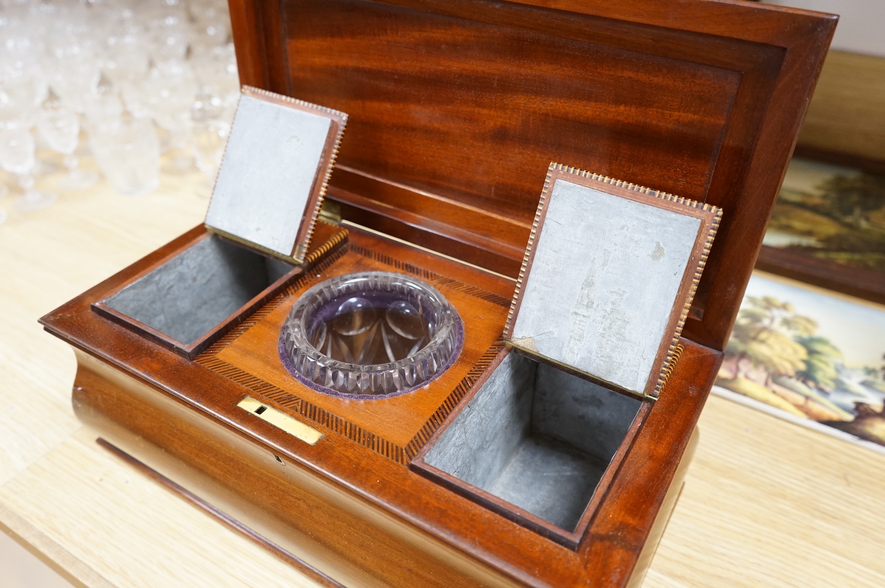 A 19th century mahogany sarcophagus tea caddy, with interior fittings, 35cm wide x 15.5cm high
